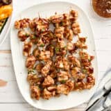 Overhead view of grilled teriyaki skewers on a platter.