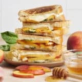 A stack of honey peach grilled cheese sandwiches.