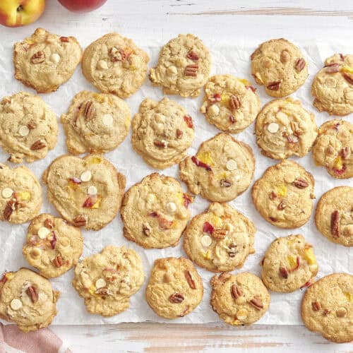 Overhead of peaches and cream cookies on a parchment lined wire rack.