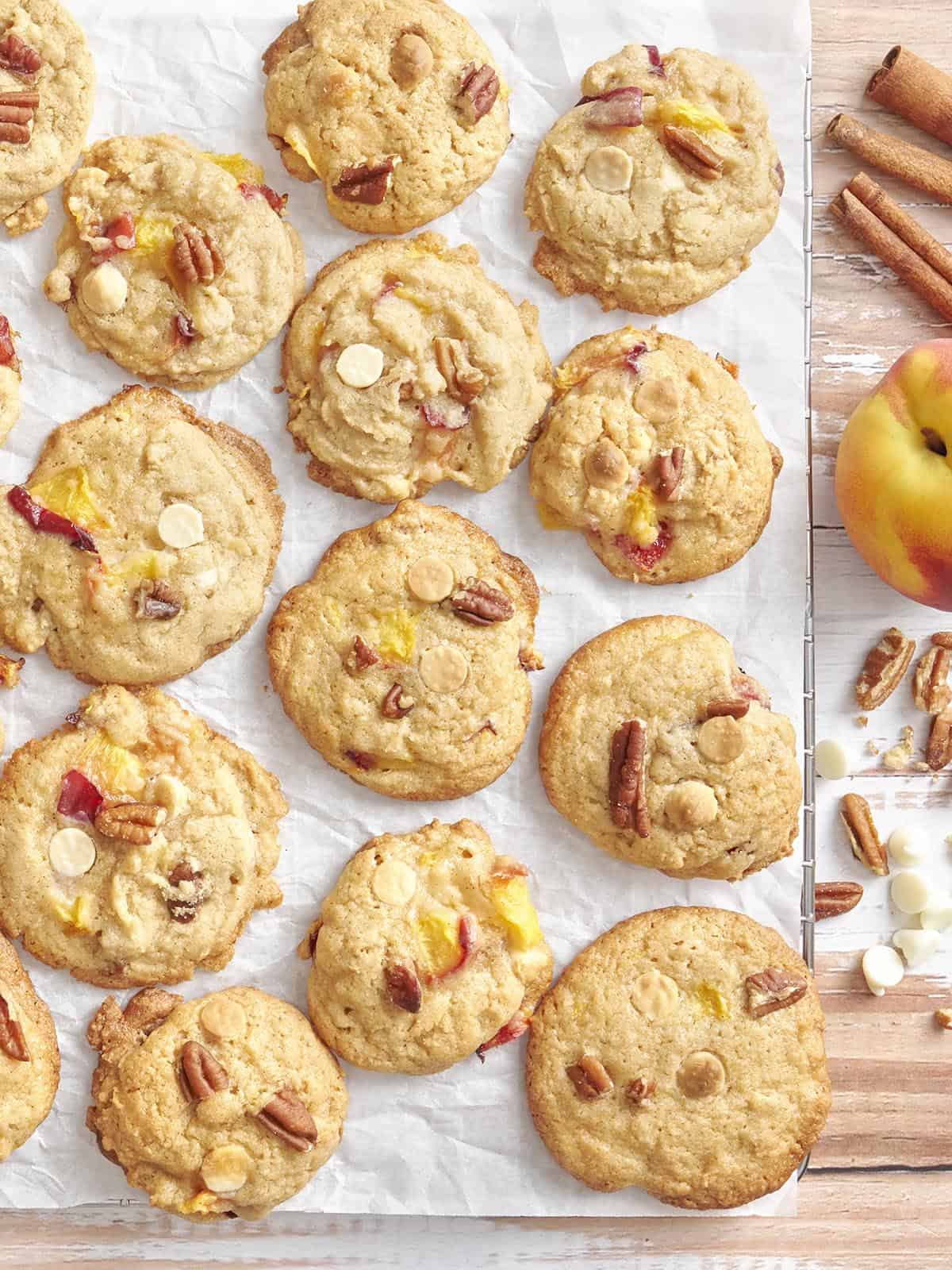 Overhead close up of homemade peaches and cream cookie on parchment paper.
