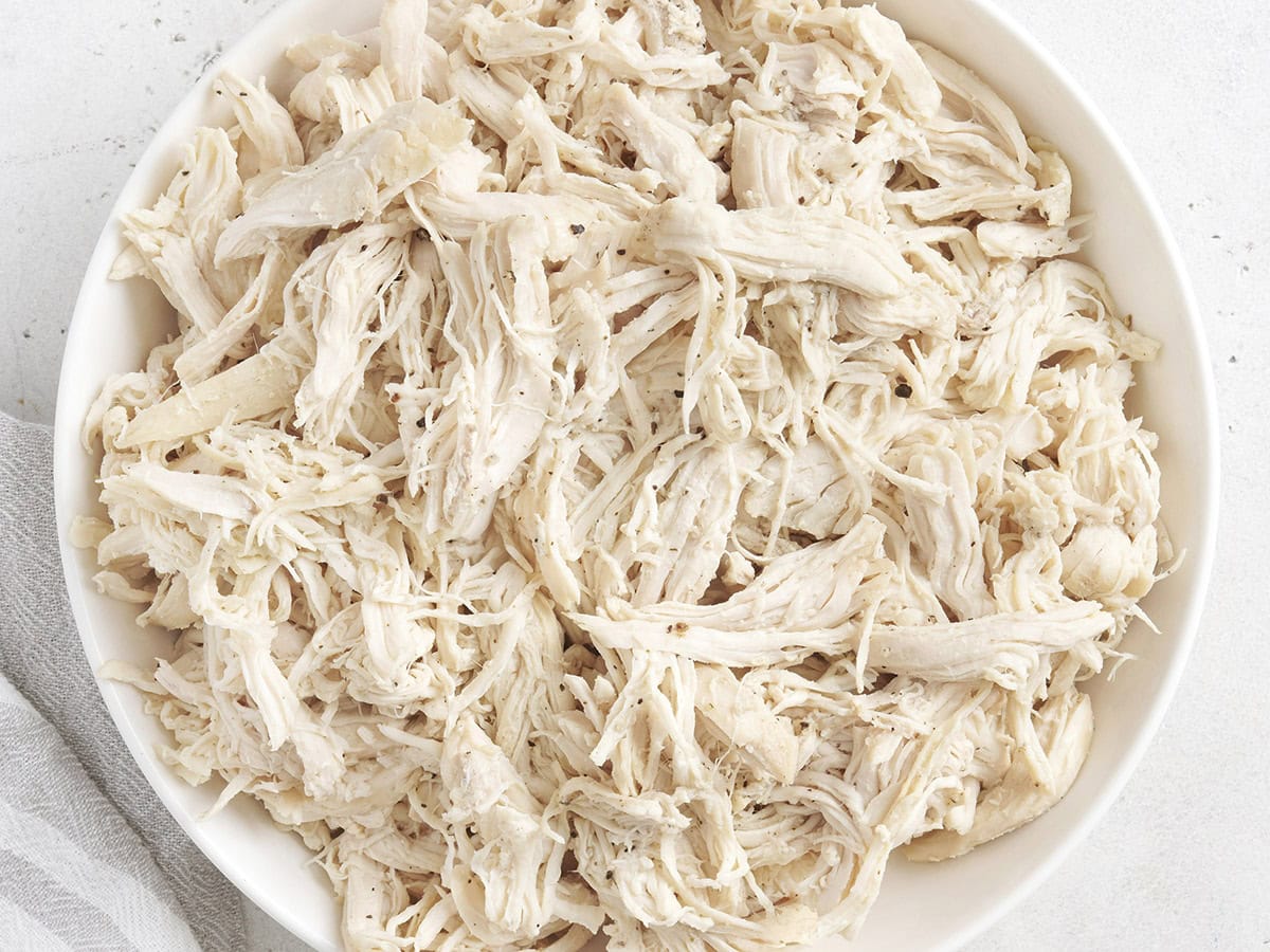 Overhead view of a bowl of pulled chicken.