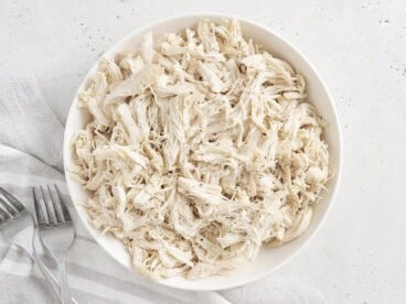 Overhead view of a bowl of pulled chicken.