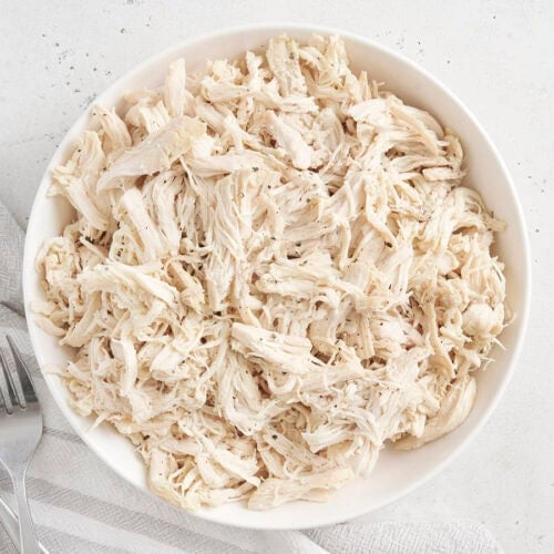Overhead view of a bowl of pulled chicken.