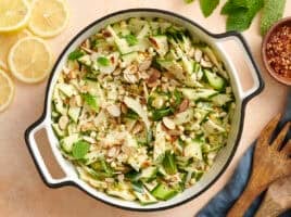 Overhead view of a bowl of zucchini, corn and toasted almond salad.