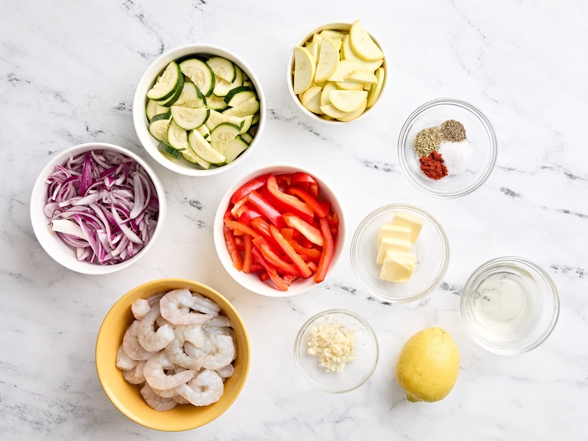 The ingredients for a shrimp and vegetable foil packet.
