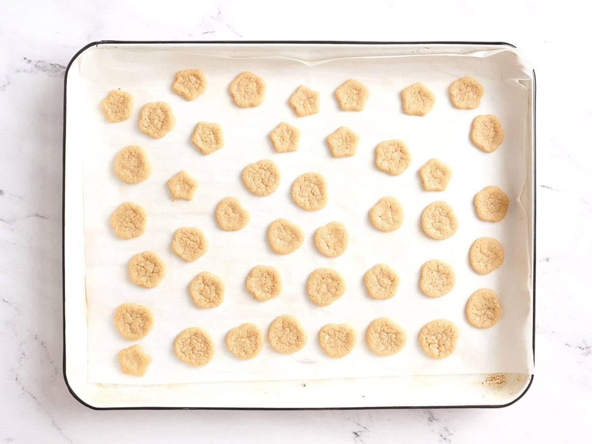 Mini cookies on a baking sheet.