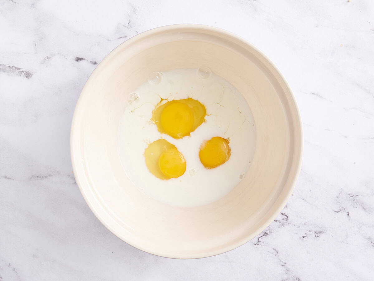 Eggs and milk in a bowl.