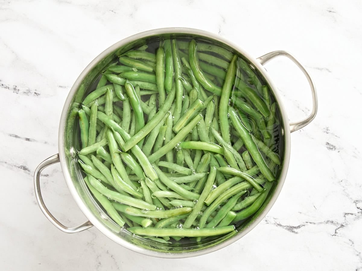 Fresh green beans blanching in hot water.