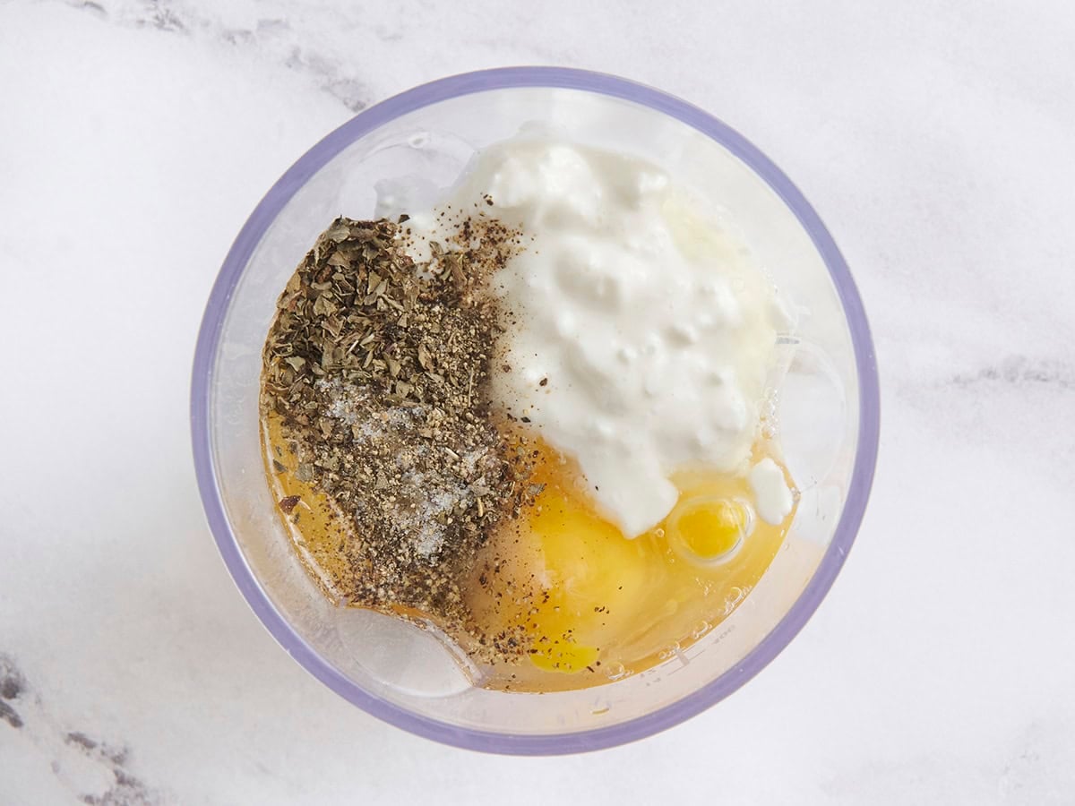 Eggs, cottage cheese, and seasonings in a mixing bowl.
