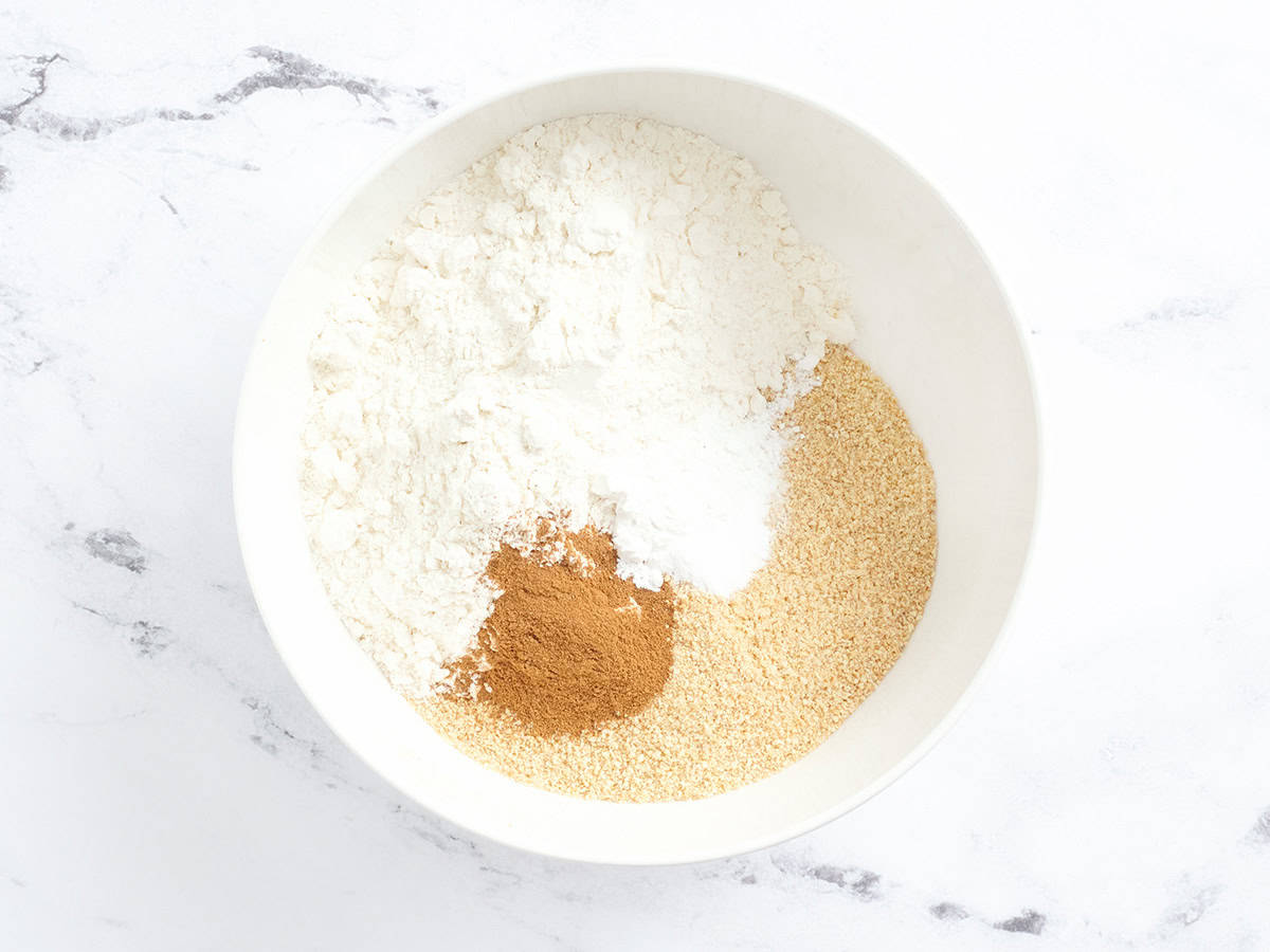 Crushed graham crackers, flour, and cinnamon in a mixing bowl.