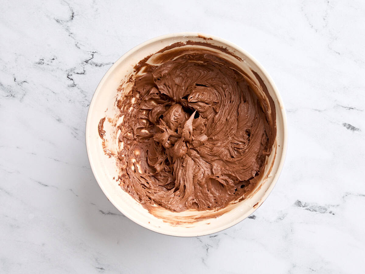 Finished chocolate butter cream in a bowl.