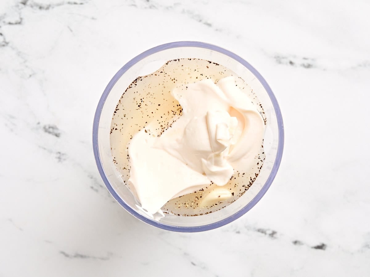 The ingredients for a fish free caesar dressing in a mixing bowl.