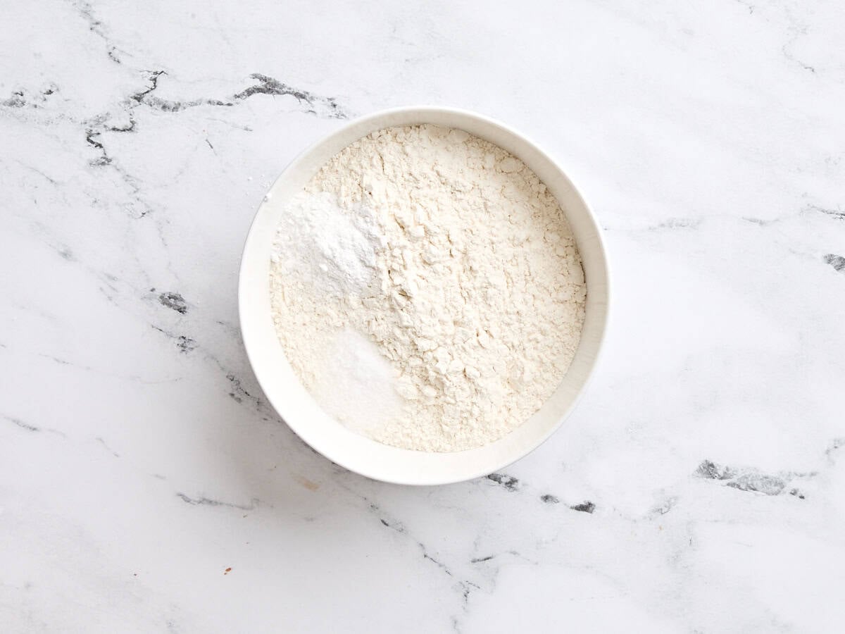 The dry ingredients for vanilla cake in a mixing bowl.