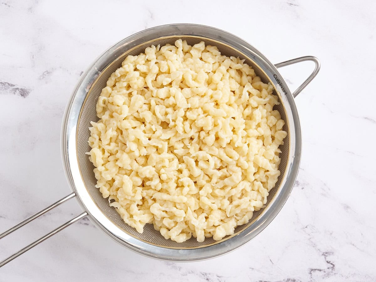 Homemade Spaetzle in a colander.
