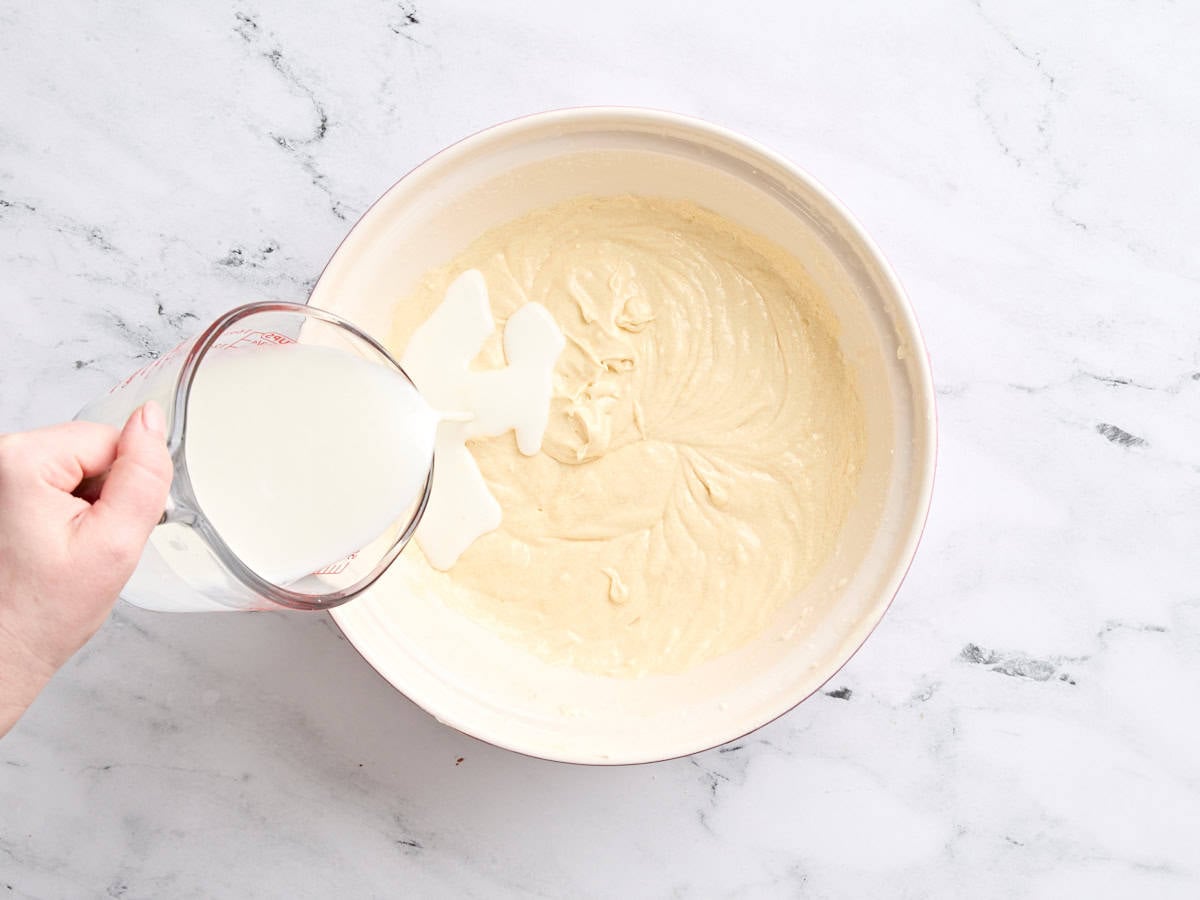 Butter milk being added to the batter for vanilla cake.