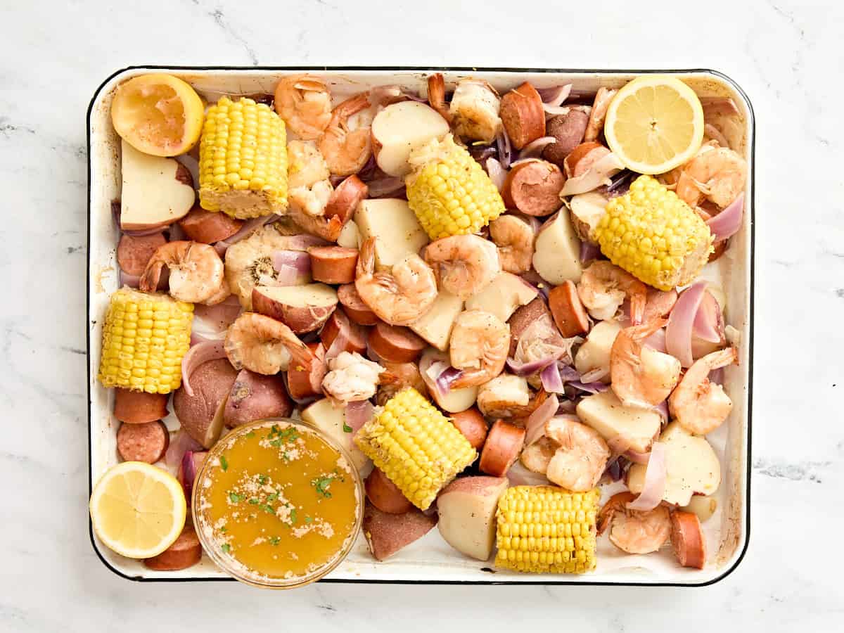 Overhead view of a shrimp boil on a sheet pan.