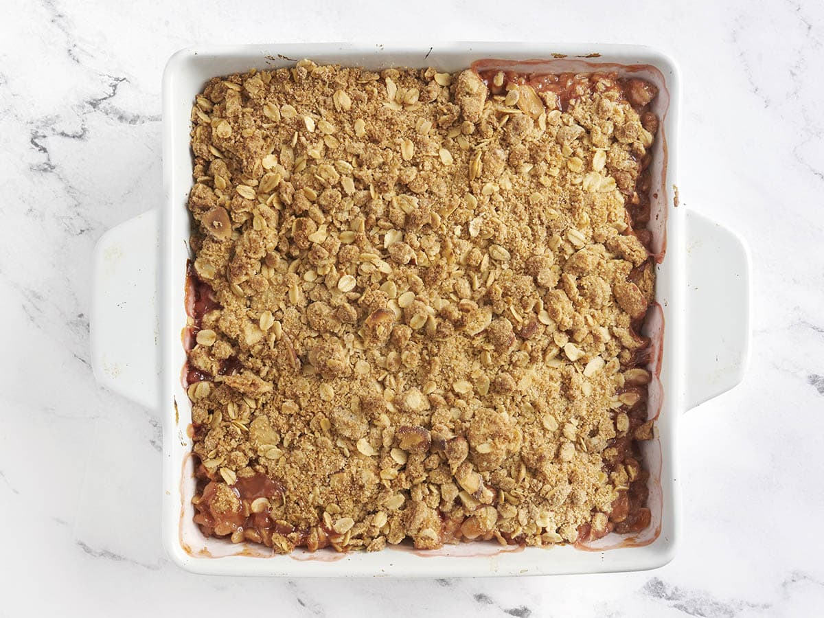 A freshly baked homemade peach crisp in a baking dish.