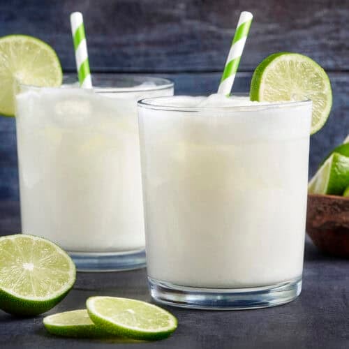 Side view of two glasses of homemade Brazilian lemonade.