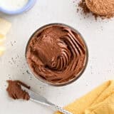 Overhead view of a pot of homemade chocolate buttercream frosting.