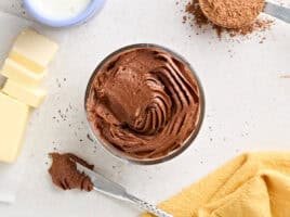 Overhead view of a pot of homemade chocolate buttercream frosting.