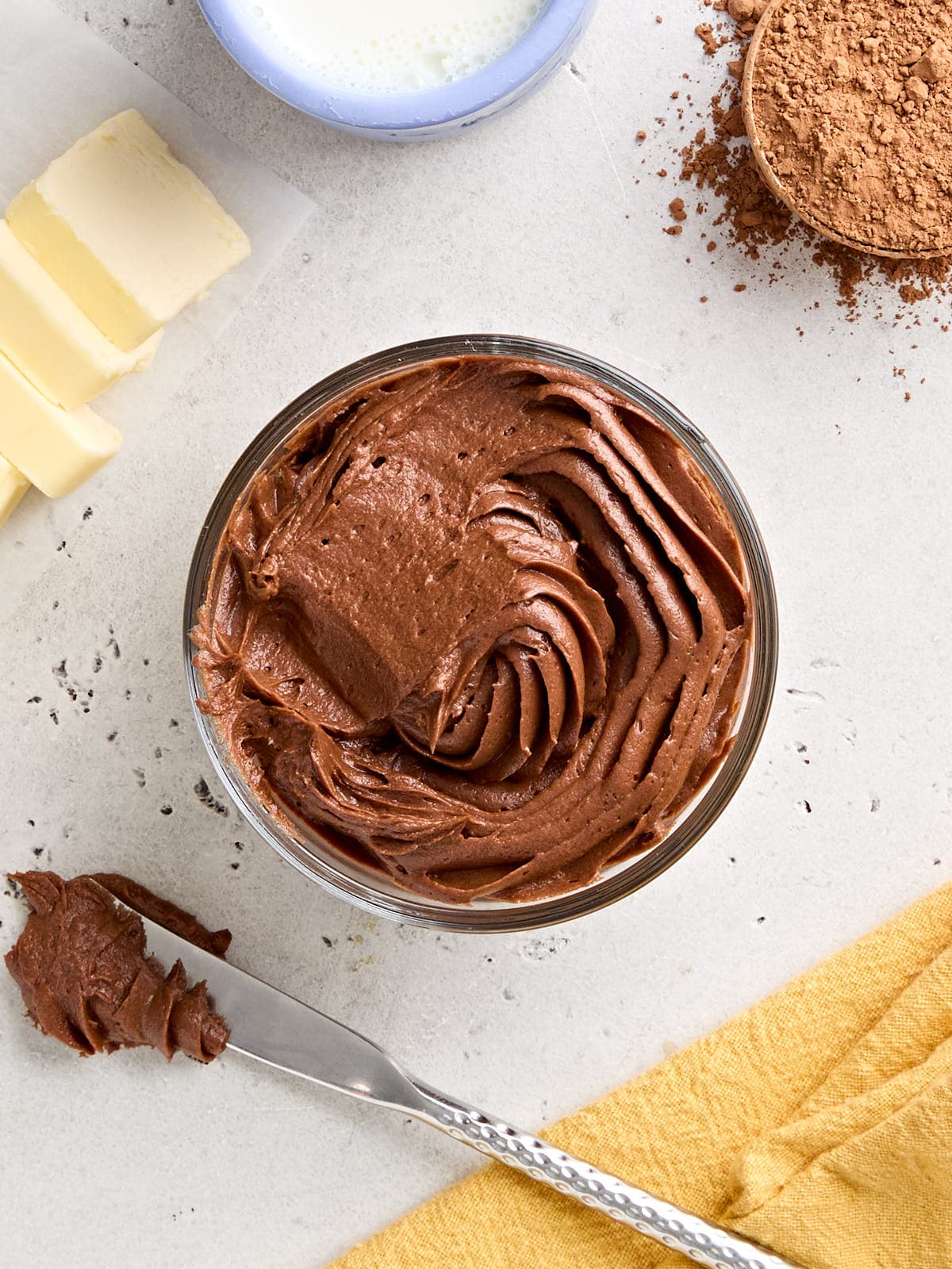 Overhead view of a pot of homemade chocolate buttercream frosting.