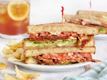 Side view of a classic blt sandwich on a plate.
