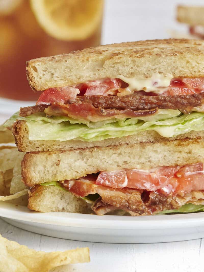 Side close up view of a classic blt sandwich on a plate.