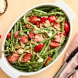 Overhead view of a green bean salad in a serving dish.