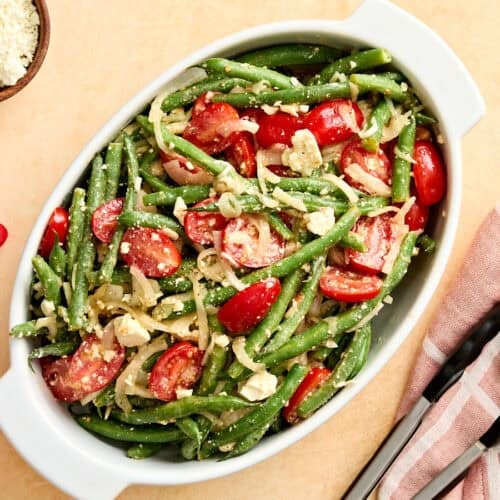 Overhead view of a green bean salad in a serving dish.