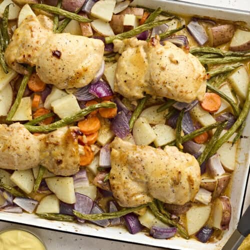 Overhead view of sheet pan honey mustard chicken with veggies.