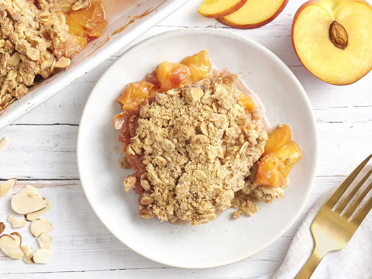 Overhead view of a bowl of peach crisp.