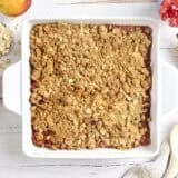 Overhead view of a peach crisp in a baking dish.