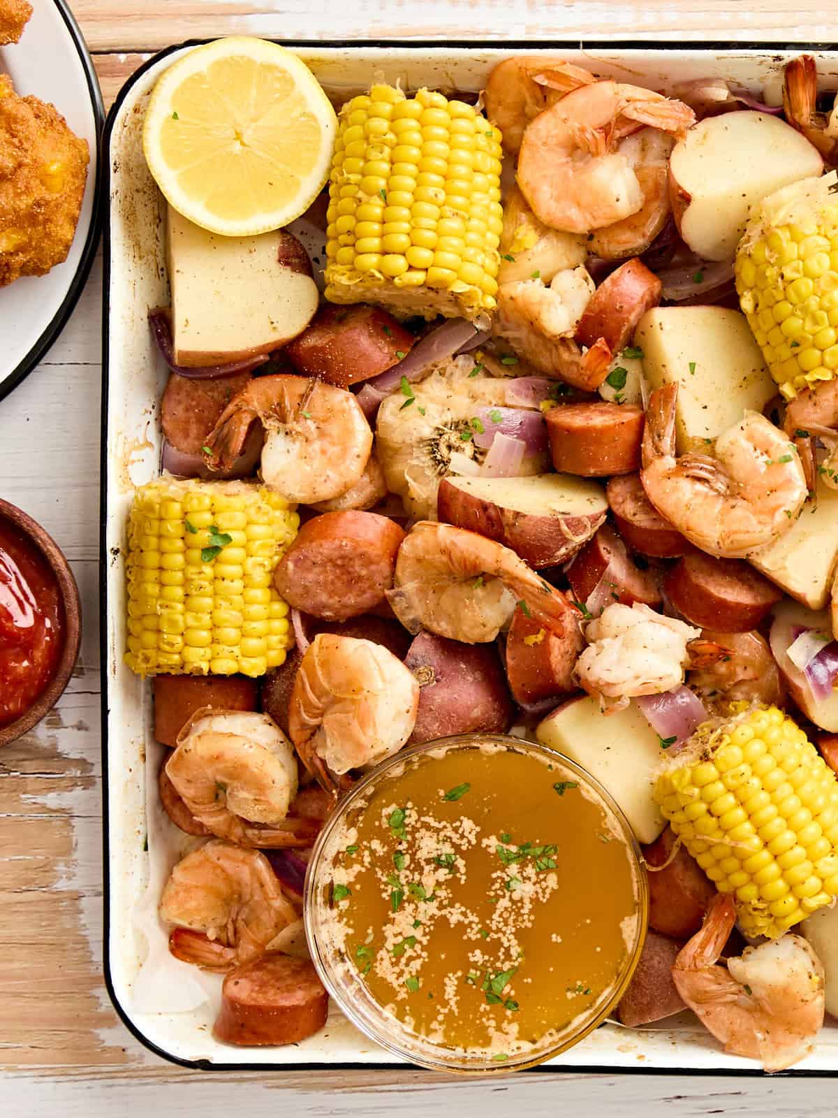 An overhead close up of a shrimp boil on a sheet pan.