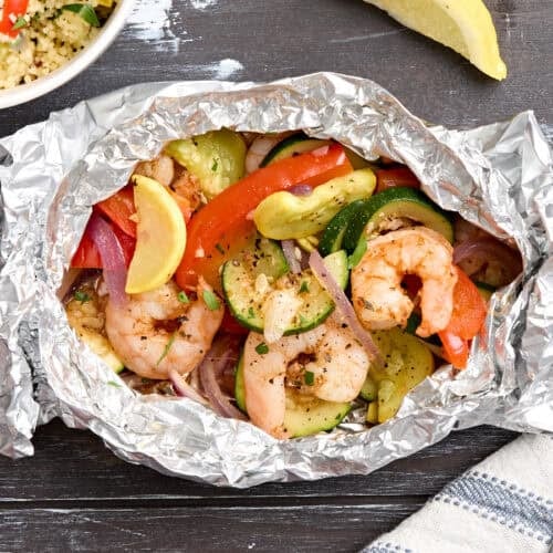 Overhead view of a grilled and veggie foil packet.