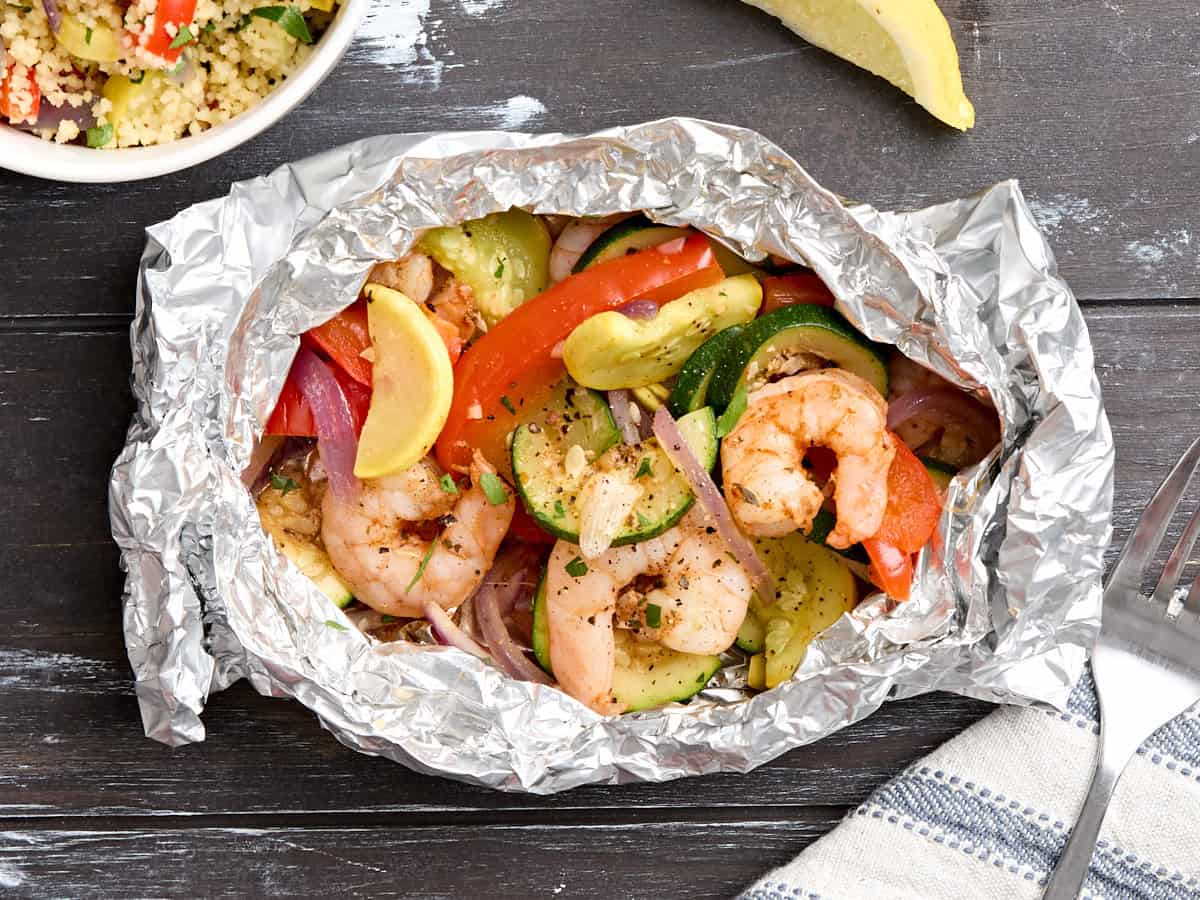 Overhead view of a grilled and veggie foil packet.