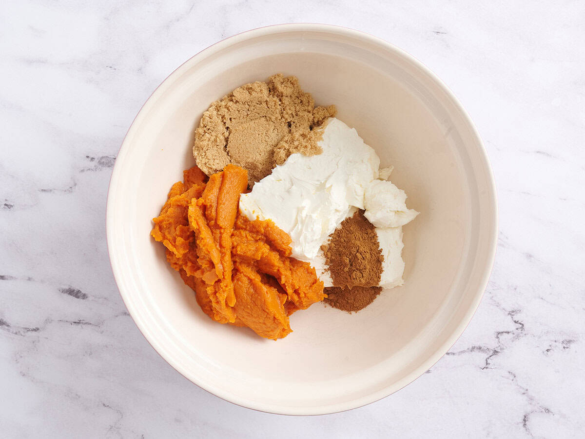 Pumpkin puree, brown sugar, cream cheese and spiced in a mixing bowl.
