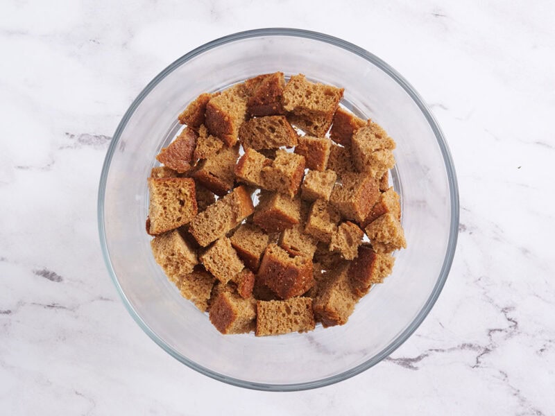 Chopped spiced cake in a trifle bowl.