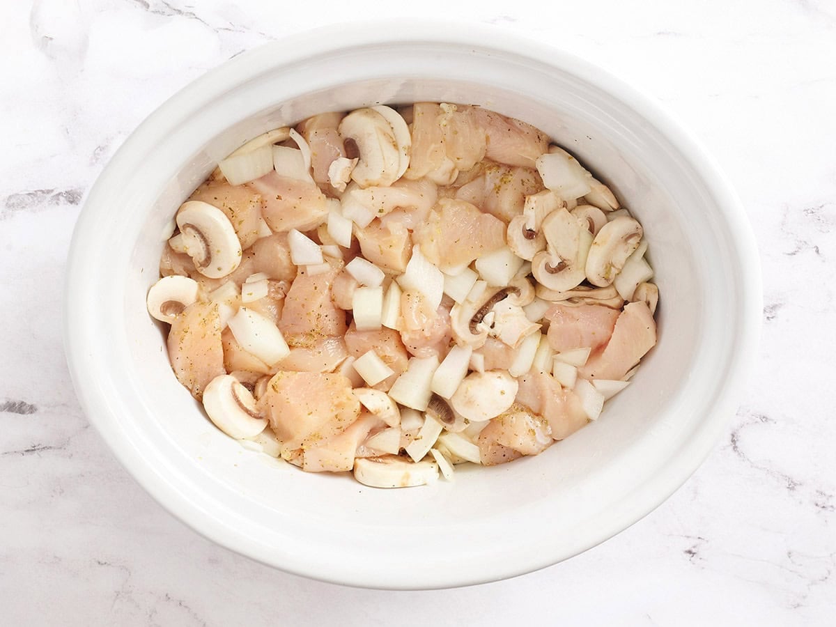 The ingredients for crockpot chicken tetrazzini in a slow cooker.