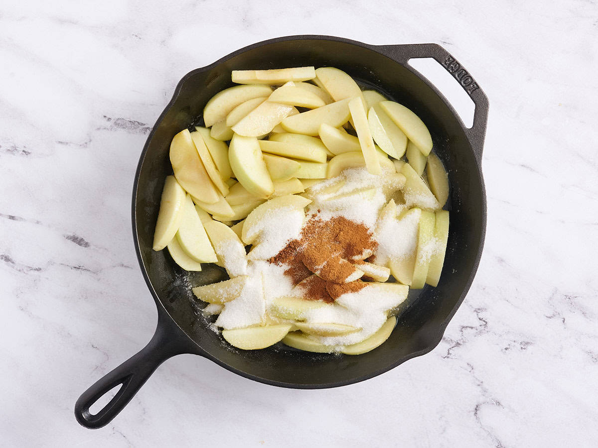 Apples, sugar, cinnamon and nutmeg in a skillet.