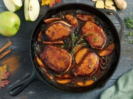 Overhead view of apple butter pork chops in a skillet.
