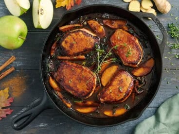 Overhead view of apple butter pork chops in a skillet.