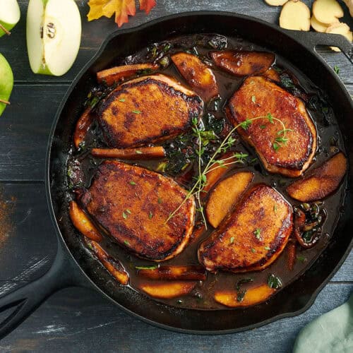 Overhead view of apple butter pork chops in a skillet.
