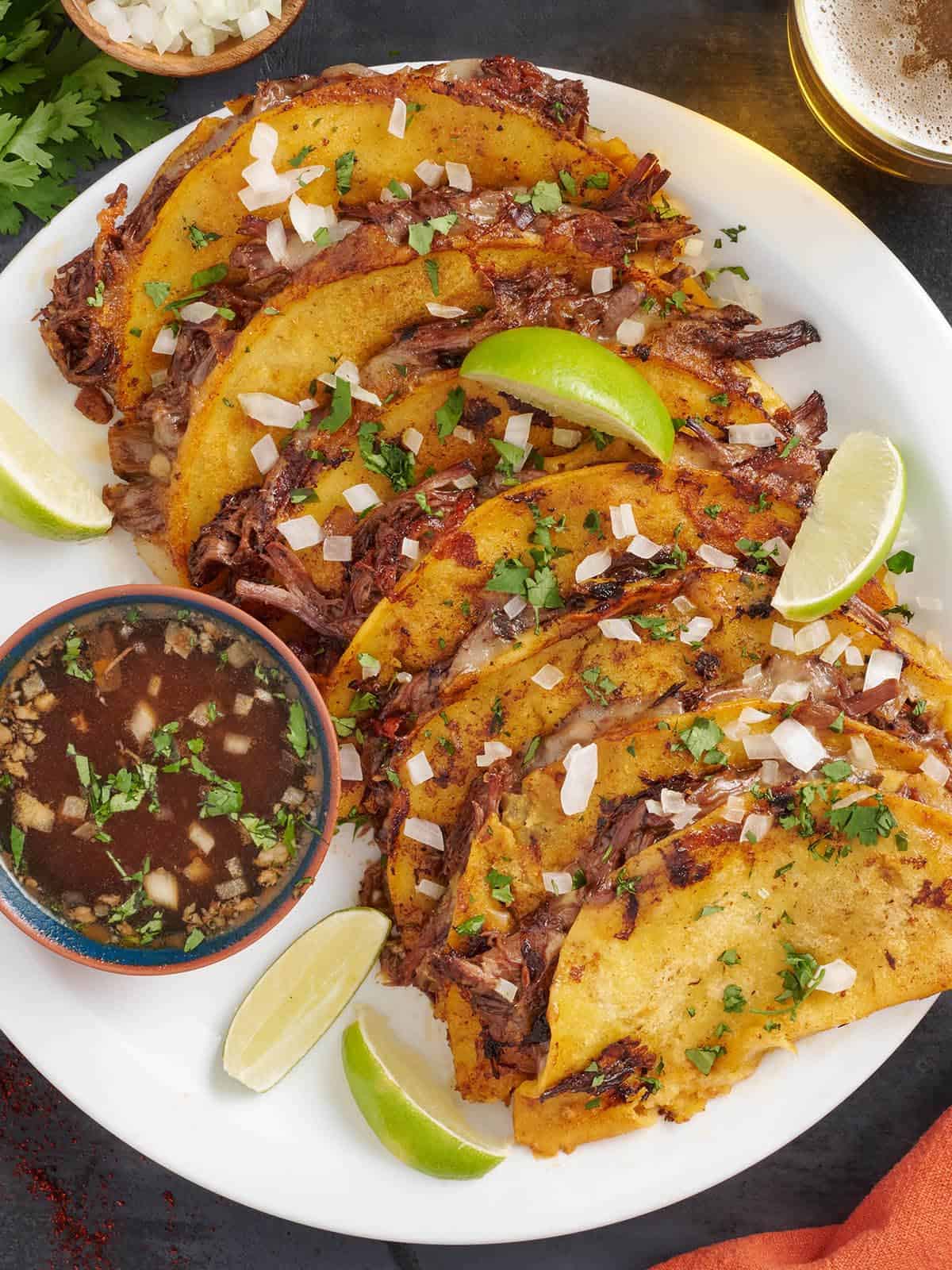 Overhead view of homemade birria tacos on a plate.
