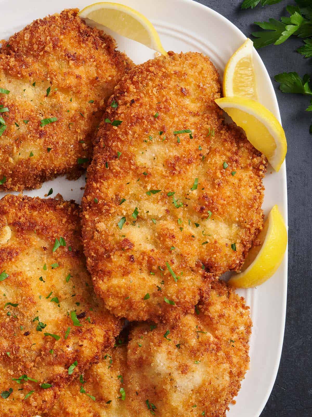 Overhead close up of homemade chicken schnitzel on a plate.