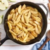 Overhead view of fried apples in a skillet.