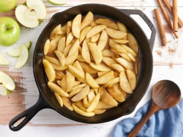 Overhead view of fried apples in a skillet.