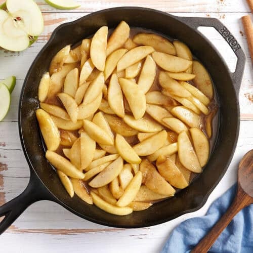 Overhead view of fried apples in a skillet.