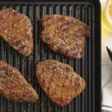 Overhead view of grilled sirloin tender steaks on a grill.