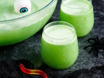 Side view of two glasses of witches brew halloween punch.