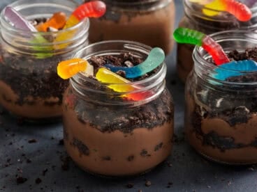 Side view of a worms in dirt dessert pudding cup.